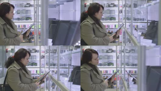 朵莉:顾客在电子商店买数码平板电脑高清在线视频素材下载