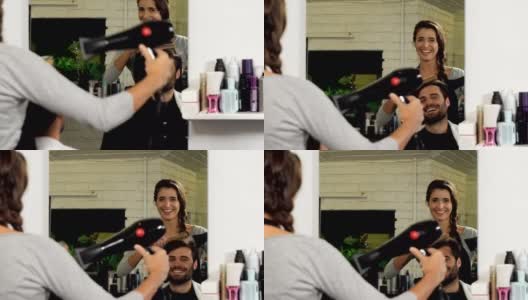 女理发师吹干她的客户的头发高清在线视频素材下载