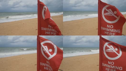 4 k。海滩上的安全信息禁止游泳标志。红旗警告说，这一地区的水是禁止进入的。游泳的环境不安全。高清在线视频素材下载