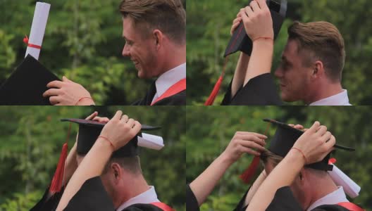 41、快乐的男毕业生戴着学位帽微笑着，毕业典礼上高清在线视频素材下载