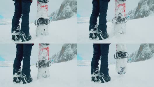 SLO MO滑雪板手把他的滑雪板插在雪地里高清在线视频素材下载