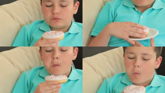 小男孩在吃甜甜圈高清在线视频素材下载