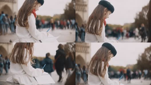 一个漂亮的小女孩拿着笔记本坐在法国巴黎圣母院附近画素描高清在线视频素材下载