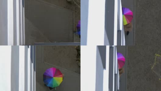男人和女人在五颜六色的伞下高清在线视频素材下载