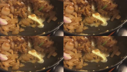 黄油在棕色洋葱锅中融化高清在线视频素材下载
