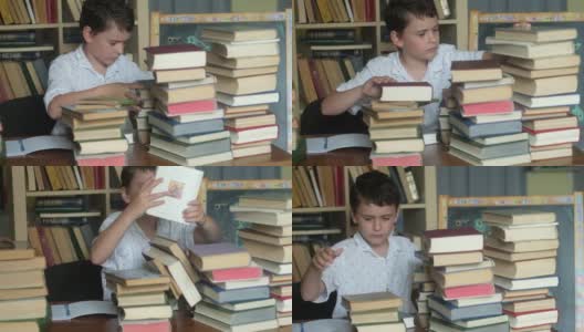 一名学童正在书桌上一堆课本中寻找他要找的书高清在线视频素材下载