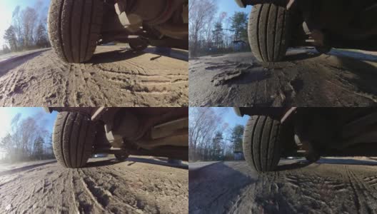 汽车在土路上行驶时的轮胎及悬架系统高清在线视频素材下载
