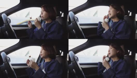 亚洲女司机在车上吃街头食物的假期早餐雾蒙蒙高清在线视频素材下载