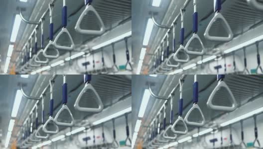 悬挂在公共交通、公共汽车或火车内部。中镜头的把手悬挂在移动的火车高清在线视频素材下载
