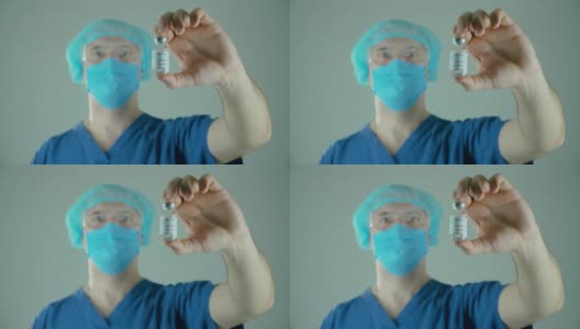 手持冠状病毒疫苗的男医生在医学实验室展示。安瓿或药瓶高清在线视频素材下载