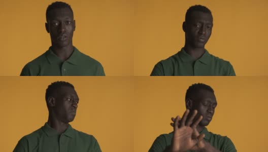年轻的非洲裔美国人在彩色背景下展示停止手势。不想看表情高清在线视频素材下载