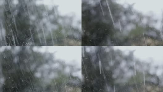 一场倾盆大雨的窗外景色。水滴从玻璃上流下。关闭了。秋天的季节高清在线视频素材下载