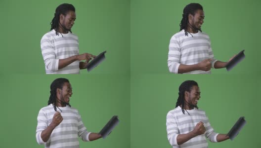 年轻英俊的非洲男子，长发绺映衬着绿色的背景高清在线视频素材下载