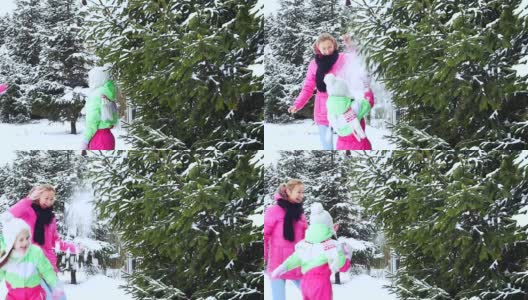 有趣,树,雪。妈妈摇树，雪花落在小女孩身上，小女孩很惊讶，很激动。高清在线视频素材下载