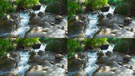 快速流动透明的水在岩石河在热带森林近距离。山河水流湍急高清在线视频素材下载