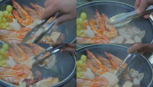 用橄榄油在煎锅里炸嫩土豆和海鲜高清在线视频素材下载