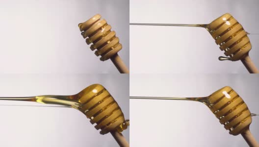 (实时和垂直)蜂蜜从一个木制的蜂蜜勺流动高清在线视频素材下载