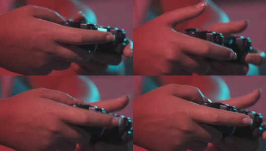 女人的手与游戏控制台控制器的特写，而玩。彩灯高清在线视频素材下载