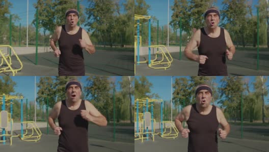 做运动的老人。老人在公园里跑步。健康的生活方式和锻炼的概念。高清在线视频素材下载