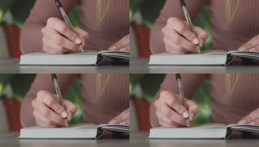 女人的手写在笔记本上高清在线视频素材下载
