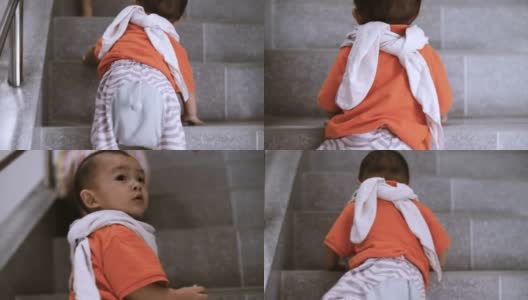 蹒跚学步的婴儿在家里“第一步”爬楼梯高清在线视频素材下载