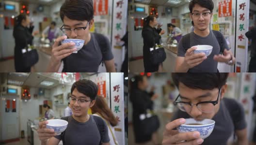 亚洲人在镜头前展示和品尝著名的中国凉茶高清在线视频素材下载