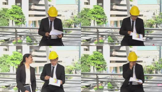 穿着正装的亚洲年轻工程师读一份新项目的报告高清在线视频素材下载