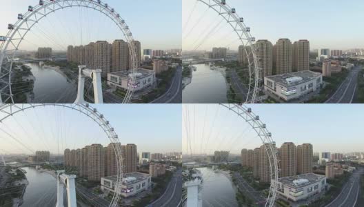 摩天轮横跨河流和现代城市高清在线视频素材下载