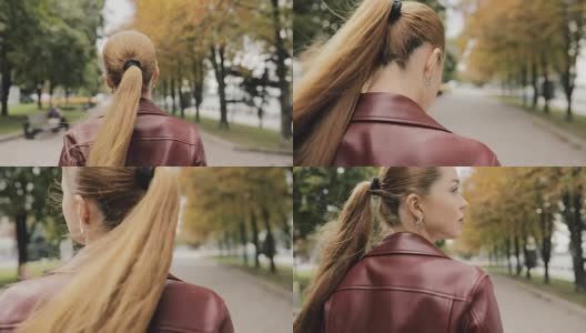 秋天来了。穿着酒红色夹克的漂亮女人走在城市街道上，慢镜头，后视镜高清在线视频素材下载