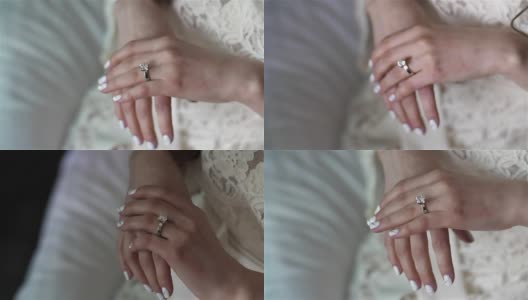 女性双手合上，用银金戒指钻石架聚焦。女人在婚礼前戴上订婚戒指，涂上指甲油，穿上蕾丝礼服。人生富有魅力财富灰姑娘高清在线视频素材下载