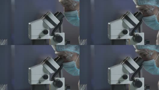 神经外科医生在显微镜下对大脑进行显微手术高清在线视频素材下载