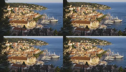 克罗地亚赫瓦尔岛，赫瓦尔市和海湾上的游艇，令人惊叹的日落高清在线视频素材下载