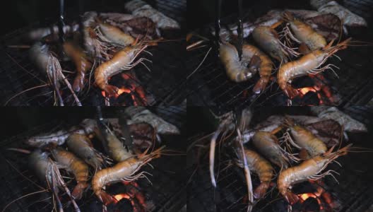 把虾和鱿鱼放在火焰烤架上。海鲜烧烤高清在线视频素材下载