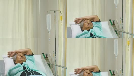 资深妇女因疼痛和失眠在医院病床上接受静脉滴注康复治疗高清在线视频素材下载