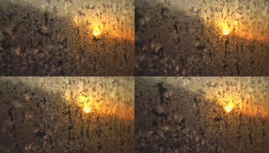 美丽的冰花在结霜的窗户上，在金色的朝阳中闪闪发光高清在线视频素材下载