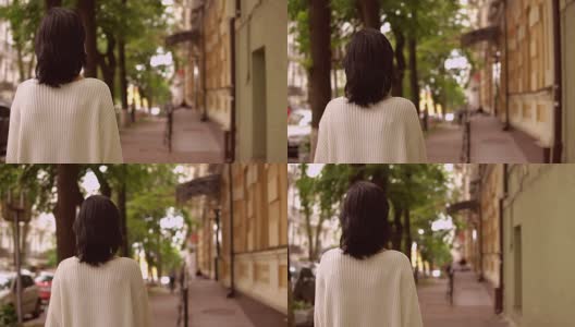一个女性在城市街道上行走的后视图高清在线视频素材下载