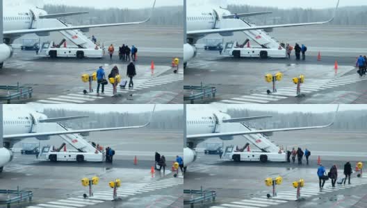 恶劣天气:旅客从机场候机楼走到登机楼梯。在国际机场登机的旅客高清在线视频素材下载