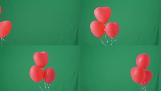 红色心形氦气球孤立在绿色屏幕背景上，情人节、生日派对的设计理念高清在线视频素材下载