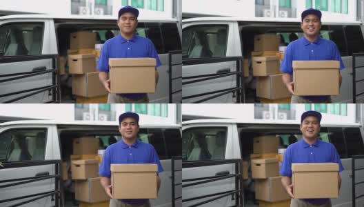 电晕病毒概念，Smiley蓝色英俊的亚洲男子拿着包裹纸箱站在货车前面。4k分辨率和慢动作拍摄。高清在线视频素材下载