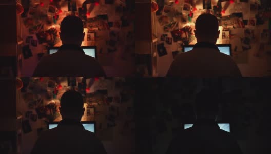 职业男性玩家坐在电脑屏幕前颜色闪烁的暗室里玩RPG网络视频游戏，集中男性玩射击游戏，与网络玩家一起参加虚拟游戏锦标赛。Cybergames和高清在线视频素材下载