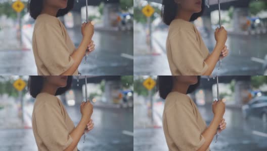 女人在雨中撑伞的慢动作高清在线视频素材下载