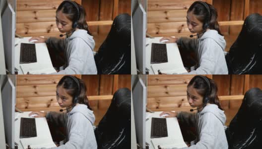 一个年轻的女孩在家里通过电脑在线课程学习高清在线视频素材下载