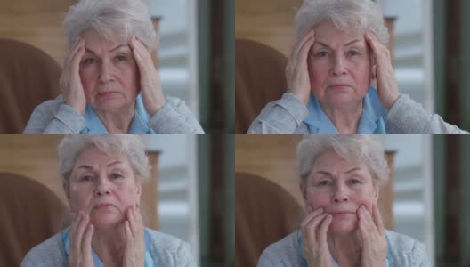 资深女性抚摸着布满皱纹的脸，表情严肃地看着镜头。焦虑悲伤的白人女性退休在家的头像。老化的概念高清在线视频素材下载