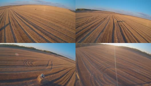 FPV无人机在秋天飞过一片麦田。干草堆,高速高清在线视频素材下载