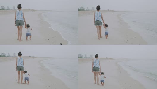 妈妈和她的儿子在海滩上放松高清在线视频素材下载
