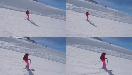 在运动中，女子滑雪者滑雪下山的山坡上高清在线视频素材下载