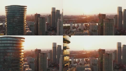 在日落时分，向前飞绕竞技场塔摩天大楼。城市的夜景一览无余。英国伦敦高清在线视频素材下载