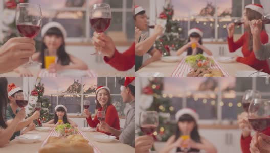 亚洲可爱的家庭成员在家里一起庆祝圣诞派对。漂亮迷人的父母在餐桌上碰杯，吃着传统的庆祝晚餐。高清在线视频素材下载