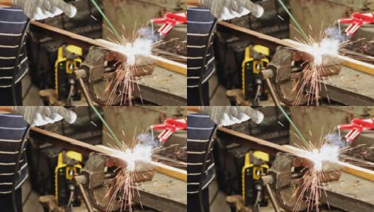 电影:工业工人在金属加工厂使用现代焊机焊接金属结构。炽热的金属发出火花。高清在线视频素材下载