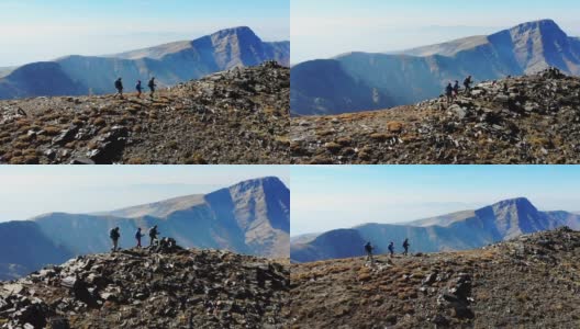 无人机拍摄的成功登山队正在攀登山脊的山顶。高清在线视频素材下载
